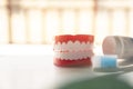 Close up Denture with toothpaste Toothbrush on blurred background.Metaphor for oral, dentures jaw toothy healthcare protect