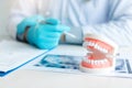 Close up dentures with dentist working on table in clinic Royalty Free Stock Photo