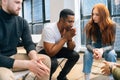 Close-up of depressed African American young man sharing problem sitting in circle on group therapy session. Royalty Free Stock Photo