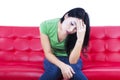 Close-up depressed woman on red sofa - isolated Royalty Free Stock Photo