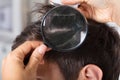 Dermatologist Checking Patient`s Hair With Magnifying Glass Royalty Free Stock Photo