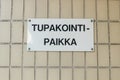 Close up of designated smoking area sign in Finnish language - Smoking place Royalty Free Stock Photo