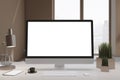 Close up of designer office desktop with empty white computer screen, window with city view, decorative items and supplies. Mock Royalty Free Stock Photo