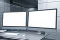 Close up of desktop with empty blank computer monitors in futuristic server room office interior. Big data and storage concept. Royalty Free Stock Photo