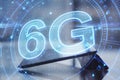 Close up of desktop with tablet and 5G network digital hologram and internet of things background. High speed internet concept.