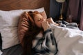 Close-up of desperate young woman crying lying alone on bed under blanket, have depression and stress, looking Royalty Free Stock Photo