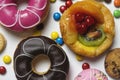 Close up of dessert with candy, chocolate and strawberry donuts and fruitcake Royalty Free Stock Photo