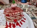 Close up of dessert served in a fancy restaurant | Strawberry and vanilla pancakes top with an ice cream scoop Royalty Free Stock Photo