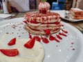 Close up of dessert served in a fancy restaurant | Strawberry and vanilla pancakes top with an ice cream scoop Royalty Free Stock Photo