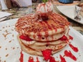 Close up of dessert served in a fancy restaurant | Strawberry and vanilla pancakes top with an ice cream scoop Royalty Free Stock Photo