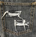 Close up of destroyed torn denim jeans patch