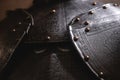 Close up detail Background with armour of the medieval knight. Metal protection of the soldier. Steel Plate. Rivets and engraving Royalty Free Stock Photo