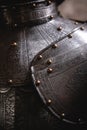 Close up detail Background with armour of the medieval knight. Metal protection of the soldier. Steel Plate. Rivets and engraving Royalty Free Stock Photo