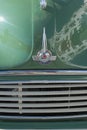 Close up detail of the badge and bonnet of the classic English car, the Morris Minor.