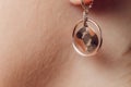 Close up Detail of a Beautiful Earring in Glamour Shot - Image of a beautiful precious piece of jewel hanging from ear. Royalty Free Stock Photo