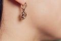 Close up Detail of a Beautiful Earring in Glamour Shot - Image of a beautiful precious piece of jewel hanging from ear. Royalty Free Stock Photo