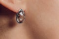 Close up Detail of a Beautiful Earring in Glamour Shot - Image of a beautiful precious piece of jewel hanging from ear. Royalty Free Stock Photo