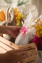 Detail of brazilian woman holding white easter egg in wooden basket at home Royalty Free Stock Photo