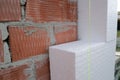 Close-up detail of brick house wall with rigid styrofoam insulation sheet. Modern technology of construction, renovation and Royalty Free Stock Photo