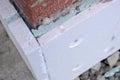 Close-up detail of brick house wall with rigid styrofoam insulation sheet. Modern technology of construction, renovation and Royalty Free Stock Photo