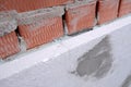 Close-up detail of brick house wall with rigid styrofoam insulation sheet. Modern technology of construction, renovation and Royalty Free Stock Photo