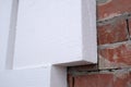 Close-up detail of brick house wall with rigid styrofoam insulation sheet. Modern technology of construction, renovation and Royalty Free Stock Photo