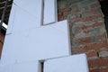 Close-up detail of brick house wall with rigid styrofoam insulation sheet. Modern technology of construction, renovation and Royalty Free Stock Photo