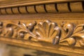 Close-up detail of carved wooden decorative piece of furniture with floral ornament made of natural hardwood. Art craft and design Royalty Free Stock Photo