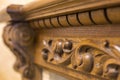 Close-up detail of carved wooden decorative piece of furniture with floral ornament made of natural hardwood. Art craft and design Royalty Free Stock Photo