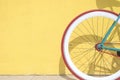 A Close-up detail of cogwheel on a vintage bicycle against a yellow wall Royalty Free Stock Photo