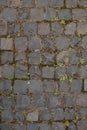 Close up of the detail of colorful cobblestones in an old street. An old road paved with granite stones. Royalty Free Stock Photo