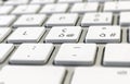 Close-up detail of a computer keyboard with white keys and a gray background Royalty Free Stock Photo