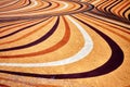 Concrete floor of a street painted in yellow with colorful curved stripes