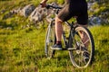 Close-up of detail of cyclist man feet riding mountain bike on rocky trail.