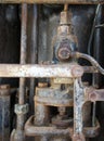 Detail of the cylinder and pipes in an old rusted decaying abandoned big petrol engine with bolts pipes and rods Royalty Free Stock Photo