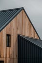 close up detail of dark grey alucobond cladding on the roof, wood slats behind it, contemporary architecture Royalty Free Stock Photo