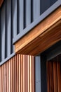 close up detail of dark grey alucobond cladding on the roof, wood slats behind it, contemporary architecture Royalty Free Stock Photo