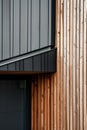 close up detail of dark grey alucobond cladding on the roof, wood slats behind it, contemporary architecture Royalty Free Stock Photo