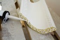 Close-up detail of decoration molding with glue adhesive before installation in interior renovation. Royalty Free Stock Photo