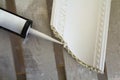 Close-up detail of decoration molding with glue adhesive before installation in interior renovation. Royalty Free Stock Photo