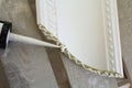 Close-up detail of decoration molding with glue adhesive before installation in interior renovation. Royalty Free Stock Photo