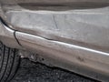 Close up detail of a dented driver door from a car crash or automobile accident. Royalty Free Stock Photo