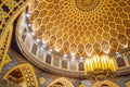 Close-up detail of the dome ceiling with yellow, brown and blue tiles decorated in Arabic style that hang with old Arabic lamp Royalty Free Stock Photo