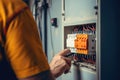 Close up detail of an electrician hands working with wires and fuse switch box Royalty Free Stock Photo