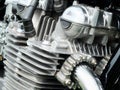 Close up detail of the engine of an old vintage motorcycle with black frame and shiny chrome exhaust pipes Royalty Free Stock Photo