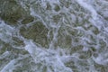 Close up detail of fierce white water river rapids from a clean deep green colored river forming a textured background Royalty Free Stock Photo