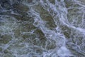 Close up detail of fierce white water river rapids from a clean deep green colored river forming a textured background Royalty Free Stock Photo