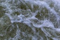 Close up detail of fierce white water river rapids from a clean deep green colored river forming a textured background Royalty Free Stock Photo