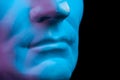 Close up detail of gypsum copy ancient statue Augustus head on black background. Plaster sculpture man face.
