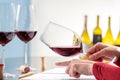 Enologist evaluating density of red wine at table. Royalty Free Stock Photo